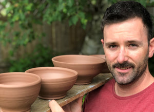 BV Ceramics- Man holding pottery